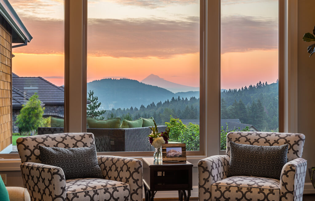 a view of the mountains around Boone from inside a cozy home with tall windows