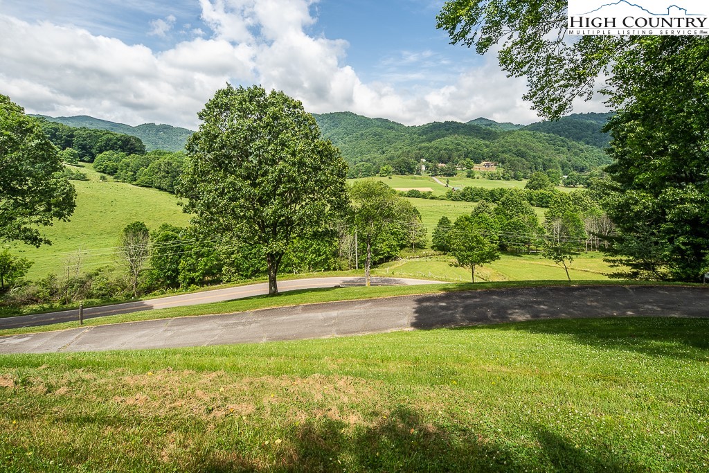 condos for sale in Blowing Rock, NC with a view, Blowing Rock NC condos, Blowing Rock condos for sale, NC Mountain Properties, Madi Doble, Green grass, green trees, rolling hills, Blue Ridge Mountains, Smoky Mountains, land for sale in Boone, Boone land for sale