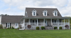 A beautiful home for sale in Boone NC, it is two stories and has a white, wrap-around porch.